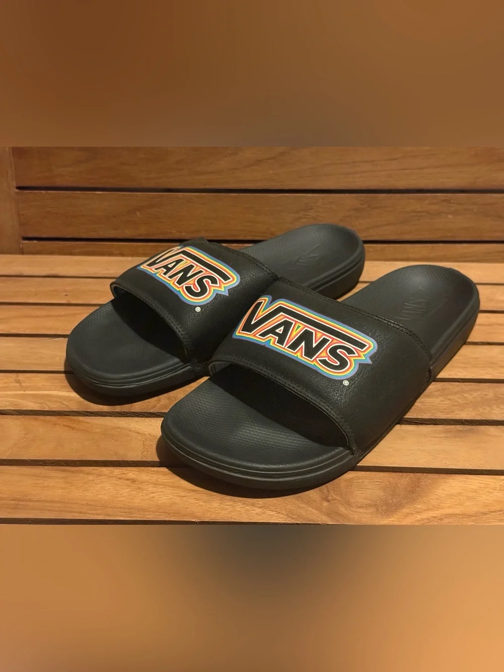 Vans La Costa slides featuring a rainbow pride logo